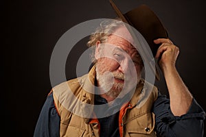 Friendly older man tipping his hat