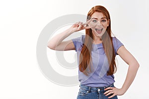 Friendly, optimistic pretty redhead woman, long ginger haircut, wear purple t-shirt, invite check out promo, showing