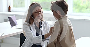 Friendly pediatrician auscultate heartbeat of child with stethoscope