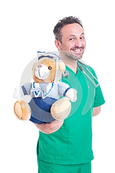 Friendly pediatrician doctor with teddy bear