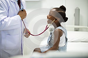 Friendly pediatrician entertaining his patient