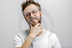 Friendly positive man looking at camera with doubting, questioning expression.