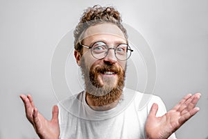 Friendly positive man looking at camera with doubting, questioning expression.