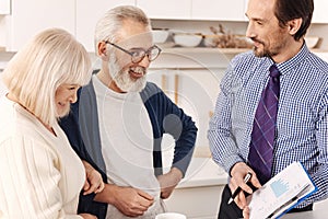 Friendly realtor presenting the contract for apartment investment to clients