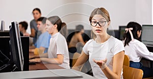 Friendly schoolgirl invites to the computer class of school