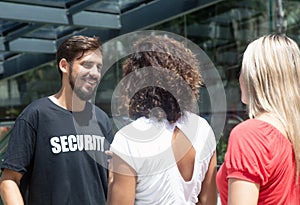 Friendly security guard checking people at the entrance