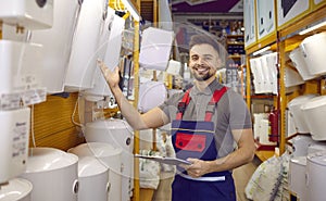 Friendly seller demonstrates wide range of thermodynamic boilers and wall-mounted water heaters. photo