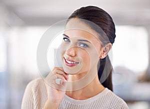 A friendly smile goes a long way. Head and shoulder view of a pretty brunette wom.