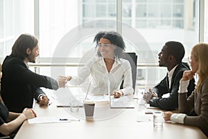 Friendly smiling african businesswoman handshaking caucasian bus