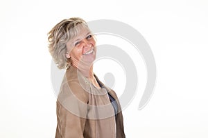 Friendly smiling blond 60 middle aged woman happy on white background