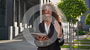 Friendly smiling Caucasian woman businesswoman with digital tablet pc in city invite come here gesture job opportunity