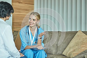 Friendly smiling doctor and patient sitting on the couch. Very good news and high level medical care concept.