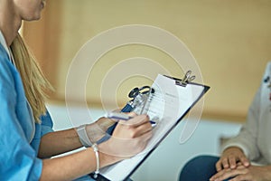 Friendly smiling doctor and patient sitting on the couch. Very good news and high level medical care concept.