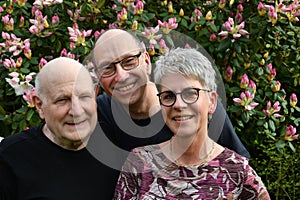 Friendly smiling family. posing for photo in their garden