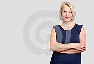 Friendly smiling middle-aged business woman on white ba
