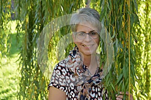 Friendly smiling middle aged woman with glasses