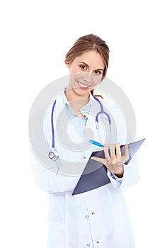 Friendly smiling young female doctor filling up medical history form, isolated over white background