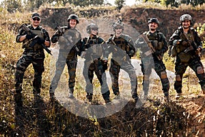 friendly team of confident army rangers before military operation soldiers against