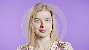 Friendly teenager girl in hippie wear showing yes signal, approve. Positive smiling lady on violet