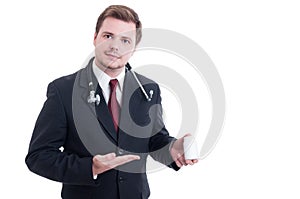 Friendly and trustworthy doctor holding and presenting a bottle