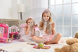 Friendly two sisters having tea party