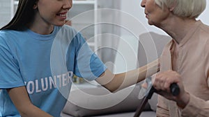 Friendly volunteer talking to retired lady, social worker supporting pensioner