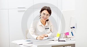 Friendly woman behind reception desk administrator