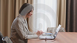 Friendly woman hotline operator in headset hold video call, talk to online client on laptop. Customer support service