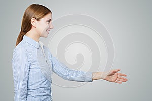 Friendly woman shaking hand on white background with copy space. Handshake woman