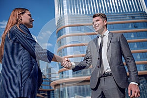 Friendly young businessman shaking hands with his business partner.