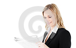 Friendly young businesswoman reading newspaper