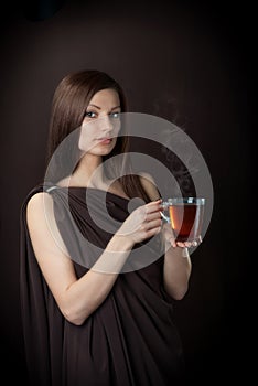 Friendly young woman with the cup of tea