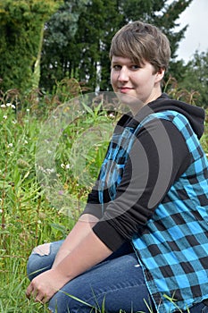 Friendly young woman in wild meadow