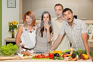 Friends acting surprised while cooking