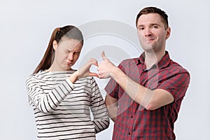 Friends aman and woman making friendzone symbol