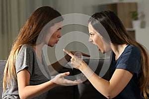 Friends arguing and shouting at home photo
