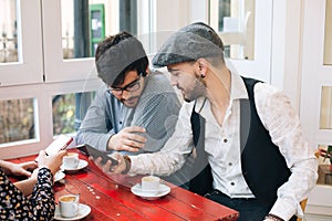 Friends in a bar using mobiles