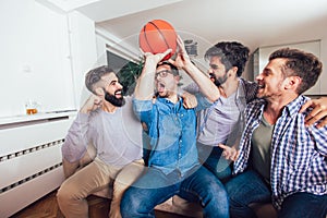 Friends or basketball fans watching basketball game on tv and celebrating victory at home.Friendship, sports and