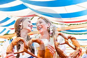 Friends at Bavarian Fair with giant pretzels