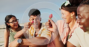 Friends, beach and picnic on holiday with fruit during happy conversation while bonding with care. Coast, food and