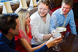 Friends with beer in a pub