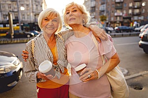 Friends being glad meeting each other in the street