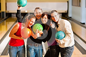 Friends bowling together