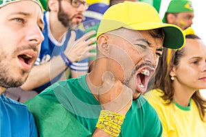 Friends from Brazil watching football match. photo