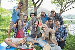 Friends camping showing thumb up