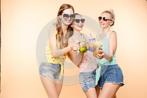 Friends in casual clothes drinking lemonade during holidays.