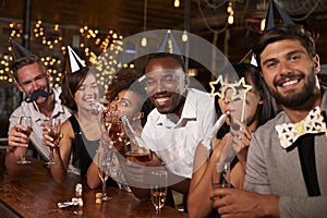 Friends celebrating New Yearï¿½s Eve at a party in a bar