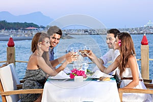 Friends celebrating at a seaside restaurant