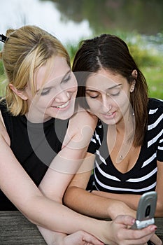 Friends on Cell Phone together (Beautiful Young Blonde and Brunette Girls)