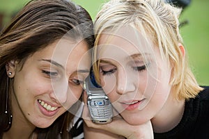 Friends on Cell Phone together (Beautiful Young Blonde and Brunette Girls)